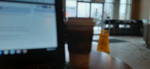 coffee cup and laptop in starbucks