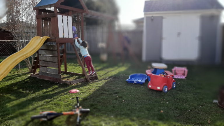 child in backyard playing foster parents
